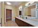 Bathroom featuring double sinks, LED mirrors, vanity, toilet and walk-in closet at 6451 Sunset Bay Cir, Apollo Beach, FL 33572