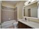 Full bathroom showcasing tiled shower-tub combo and sleek LED mirror at 6451 Sunset Bay Cir, Apollo Beach, FL 33572