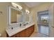 Bathroom features a double sink, white countertops, dark cabinetry and LED mirrors at 6451 Sunset Bay Cir, Apollo Beach, FL 33572