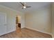 Bedroom featuring hardwood floors with an adjacent bathroom at 6451 Sunset Bay Cir, Apollo Beach, FL 33572