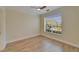 Bright bedroom with wood floors, ceiling fan and large window at 6451 Sunset Bay Cir, Apollo Beach, FL 33572