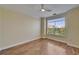 An airy bedroom featuring wood floors and a large window at 6451 Sunset Bay Cir, Apollo Beach, FL 33572