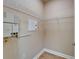 Small walk-in closet with wire shelving, cream-colored walls, and light wood-look floors at 6451 Sunset Bay Cir, Apollo Beach, FL 33572