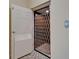 Residential elevator with a metal-grate door and a button to call the elevator at 6451 Sunset Bay Cir, Apollo Beach, FL 33572