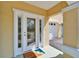 Close-up of the home's front door and entryway with covered porch at 6451 Sunset Bay Cir, Apollo Beach, FL 33572