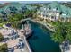 Gorgeous waterfront condos showcasing a unique water feature with charming walkways and meticulously manicured landscaping at 6451 Sunset Bay Cir, Apollo Beach, FL 33572