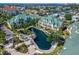 Beautiful waterfront condos featuring lush landscaping, a lovely water feature, and well-maintained grounds at 6451 Sunset Bay Cir, Apollo Beach, FL 33572