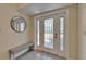 The foyer showcases a decorative glass door, neutral walls, and a woven bench at 6451 Sunset Bay Cir, Apollo Beach, FL 33572