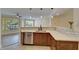 Modern kitchen featuring stainless steel appliances, quartz countertops, and stylish pendant lighting at 6451 Sunset Bay Cir, Apollo Beach, FL 33572