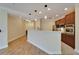 Open-concept kitchen with stainless steel appliances and eat-in counter, flowing into the spacious living area at 6451 Sunset Bay Cir, Apollo Beach, FL 33572