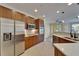 Well-lit kitchen features stainless steel appliances and wood cabinetry at 6451 Sunset Bay Cir, Apollo Beach, FL 33572