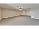 Open living room boasts neutral carpet, recessed lights, and access to other areas at 6451 Sunset Bay Cir, Apollo Beach, FL 33572
