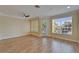 Spacious living room with modern ceiling fan, balcony access, and bright windows for natural light at 6451 Sunset Bay Cir, Apollo Beach, FL 33572