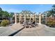 Outdoor lounge area with beautiful columns, seating, and landscaping with a view of the building and canal at 6451 Sunset Bay Cir, Apollo Beach, FL 33572