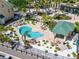 Community kidney-shaped pool surrounded by a manicured landscape and comfortable lounge chairs at 6451 Sunset Bay Cir, Apollo Beach, FL 33572
