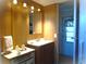 Bathroom featuring a white sink with brown cabinets and drawers with wood-paneled walls and a mirror at 652 54Th S Ln # 153, Gulfport, FL 33707