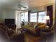 Warm and inviting living room features plush seating, a ceiling fan, plus plenty of natural light and peaceful ambiance at 652 54Th S Ln # 153, Gulfport, FL 33707