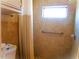 Bright shower with light brown tiling featuring a handrail and shower curtain at 652 54Th S Ln # 153, Gulfport, FL 33707