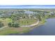 Aerial view showcases the lake, playground and open field within this Primary-planned community at 7338 Milestone Dr, Apollo Beach, FL 33572