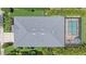 Aerial view of a single-Gathering home featuring a screened-in pool and well manicured lawn at 7338 Milestone Dr, Apollo Beach, FL 33572