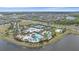 Aerial view of community clubhouse, pool, tennis courts, and surrounding neighborhood at 7338 Milestone Dr, Apollo Beach, FL 33572