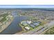 Aerial view of community amenities featuring pool, tennis courts, and a beautiful lake at 7338 Milestone Dr, Apollo Beach, FL 33572
