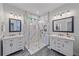 Elegant bathroom featuring marble walk-in shower, dual sinks, and modern lighting fixtures at 7338 Milestone Dr, Apollo Beach, FL 33572