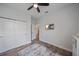 Bedroom with ceiling fan features gray wood-look tile flooring and closet at 7338 Milestone Dr, Apollo Beach, FL 33572