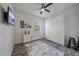 This bedroom boasts a murphy bed, ceiling fan, and gray wood-look tile flooring at 7338 Milestone Dr, Apollo Beach, FL 33572