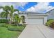 Lovely single-Gathering home showcasing a well-maintained lawn and a two-car garage at 7338 Milestone Dr, Apollo Beach, FL 33572