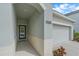 House front with a two car garage and a welcoming entryway to the front door at 7338 Milestone Dr, Apollo Beach, FL 33572