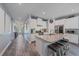 Open-concept kitchen with an island featuring granite countertops and stainless steel appliances at 7338 Milestone Dr, Apollo Beach, FL 33572