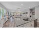 Modern kitchen with granite countertops, stainless steel appliances and open view to living spaces at 7338 Milestone Dr, Apollo Beach, FL 33572