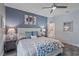 Bright main bedroom with blue accent wall, ceiling fan, and ensuite bathroom at 7338 Milestone Dr, Apollo Beach, FL 33572