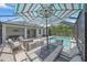 Screened-in patio with an outdoor dining table and furniture with a pool view at 7338 Milestone Dr, Apollo Beach, FL 33572