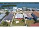Aerial view of property showing house on canal, surrounded by lush landscape and neighboring homes at 763 182Nd E Ave, Redington Shores, FL 33708