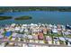 Aerial view of property showing house on canal, surrounded by lush landscape and neighboring homes at 763 182Nd E Ave, Redington Shores, FL 33708