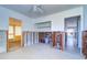 Unfinished bedroom featuring a doorway, concrete block walls, doorway leading to enclosed porch and doorway to hallway at 763 182Nd E Ave, Redington Shores, FL 33708