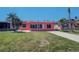 Single-story waterfront home with a large front yard and mature palm trees at 763 182Nd E Ave, Redington Shores, FL 33708