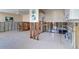 Partially renovated kitchen/living area featuring tiled flooring, bar and modern appliances; ready for remodeling at 763 182Nd E Ave, Redington Shores, FL 33708