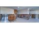 Spacious living room featuring tiled floor, ceiling fan, and bar area, ready for renovation at 763 182Nd E Ave, Redington Shores, FL 33708