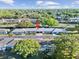 The home is surrounded by lush trees in a community with sidewalks and a beautiful landscape at 8244 Brentwood Rd, Seminole, FL 33777