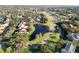 Aerial view of a neighborhood with a golf course, lakes, and walking trails at 8244 Brentwood Rd, Seminole, FL 33777