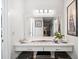 A stylish vanity area features ample counter space, drawers, and a mirror illuminated by modern lighting at 8244 Brentwood Rd, Seminole, FL 33777