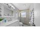 Elegant bathroom featuring a new vanity, modern fixtures, a glass-enclosed shower, and tasteful decor at 8244 Brentwood Rd, Seminole, FL 33777