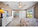 Bright bedroom featuring light wood floors, a ceiling fan, and a large window with natural light at 8244 Brentwood Rd, Seminole, FL 33777