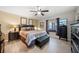 Cozy bedroom features a ceiling fan, comfortable queen bed, and ensuite bath and closet at 8244 Brentwood Rd, Seminole, FL 33777