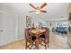 Bright dining area perfect for Gathering meals, featuring a ceiling fan and easy access to the adjoining living room at 8244 Brentwood Rd, Seminole, FL 33777
