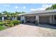Well-maintained home featuring a two-car garage, colorful landscaping, and inviting curb appeal at 8244 Brentwood Rd, Seminole, FL 33777