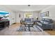 Cozy living room features a comfortable seating arrangement, natural light, and tiled floors at 8244 Brentwood Rd, Seminole, FL 33777
